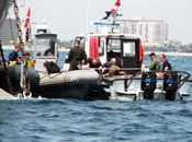 U.S. military divers boarding a boat to take them back to shore after completing a days work.