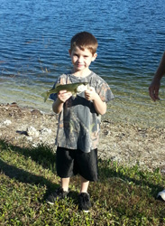 Boy holding up fish